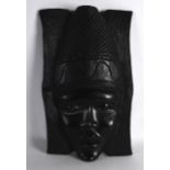 AN AFRICAN CARVED HARDWOOD MASK. 1ft 4ins high.