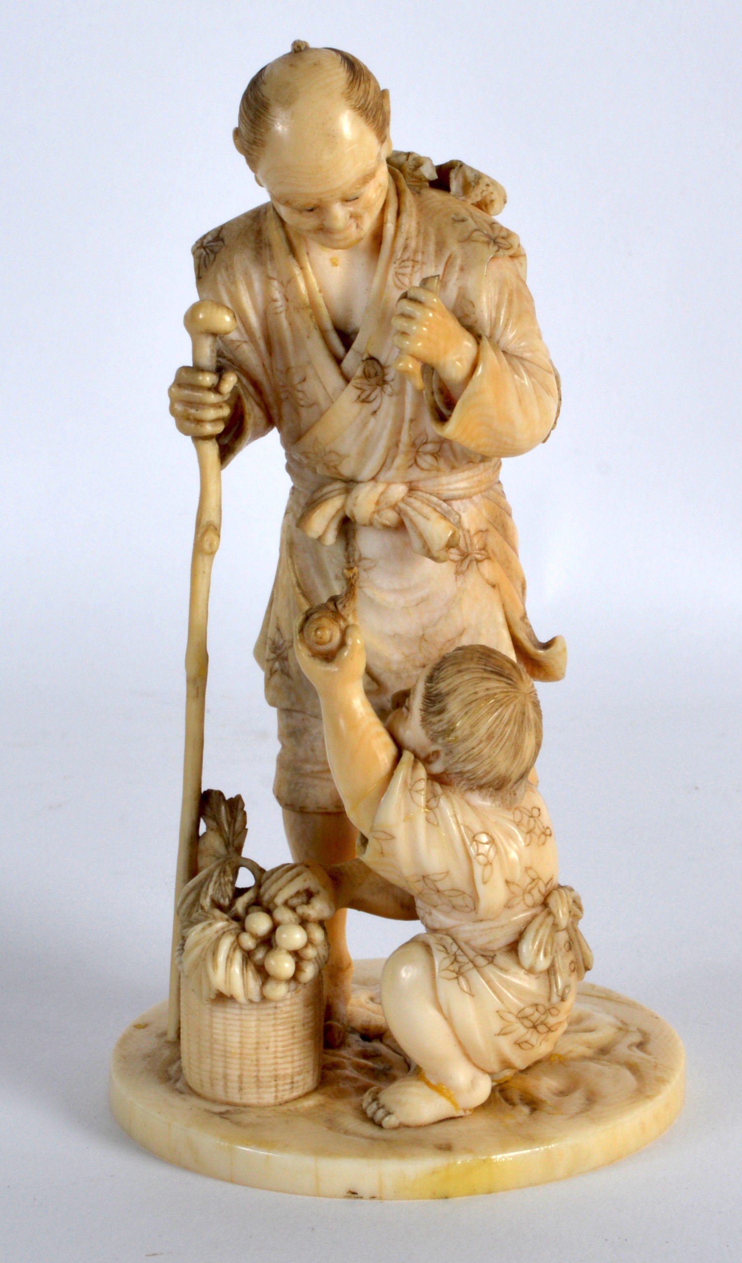 A LATE 19TH CENTURY JAPANESE MEIJI PERIOD CARVED IVORY OKIMONO modelled as a male and his son