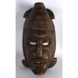 AN AFRICAN CARVED WOODEN MASK. 11.25ins long.