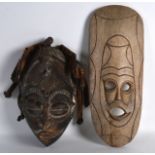 A WEST AFRICAN CHOKWE CARVED WOOD MASK together with another lightwood shallow mask. 12.5ins & 1ft