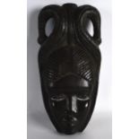 AN AFRICAN CARVED HARDWOOD MASK. 1ft 1ins high.