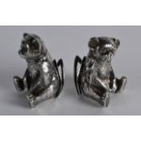 A PAIR OF EDWARDIAN SILVER MENU HOLDERS in the form of seated bears. 1.75ins high.