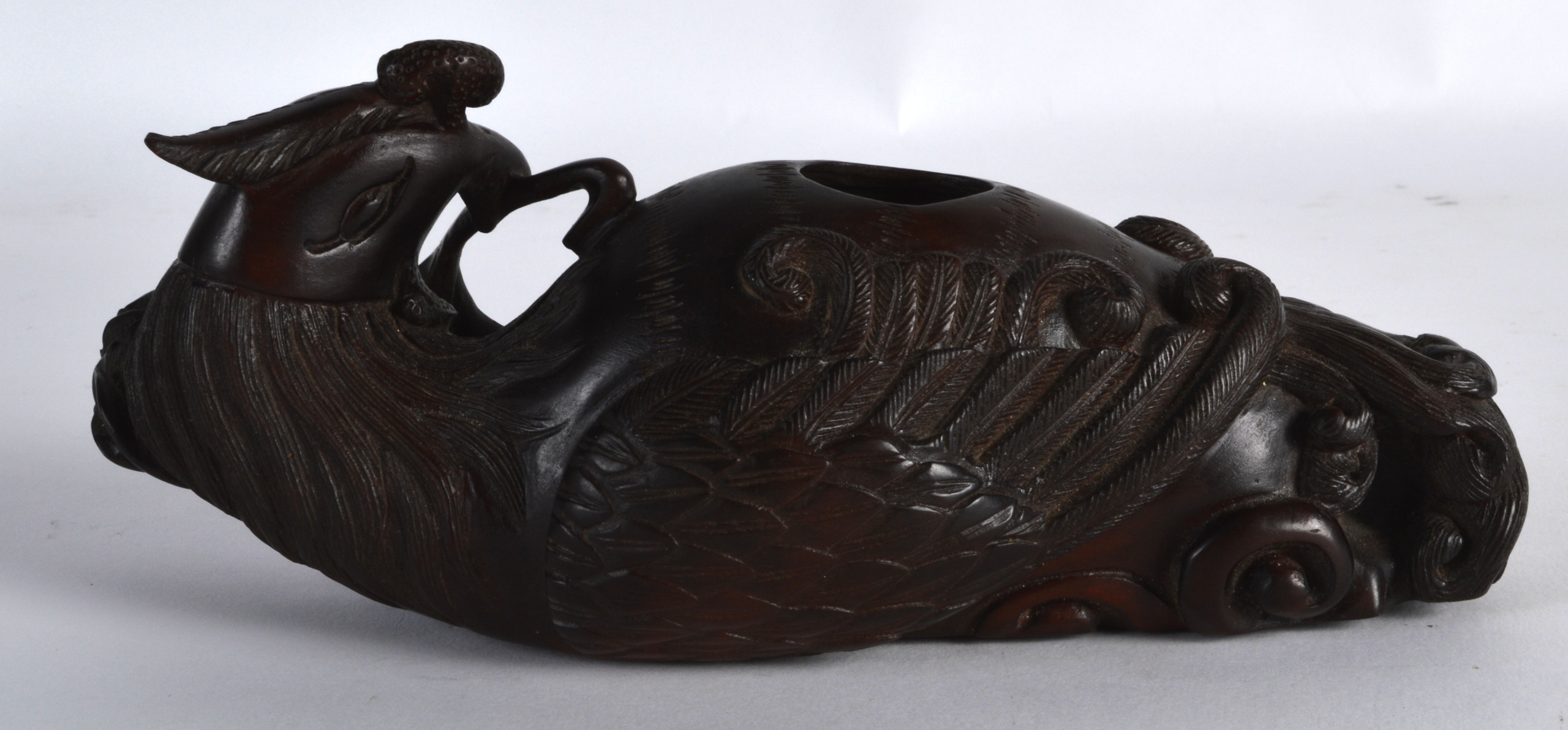 AN EARLY 20TH CENTURY CARVED HARDWOOD BRUSH WASHER Qing/Republic, modelled as a hoho bird holding - Image 2 of 3