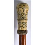 A GEORGE III CARVED IVORY PIQUE WORK WALKING CANE with swirling decoration to the terminal. 2ft