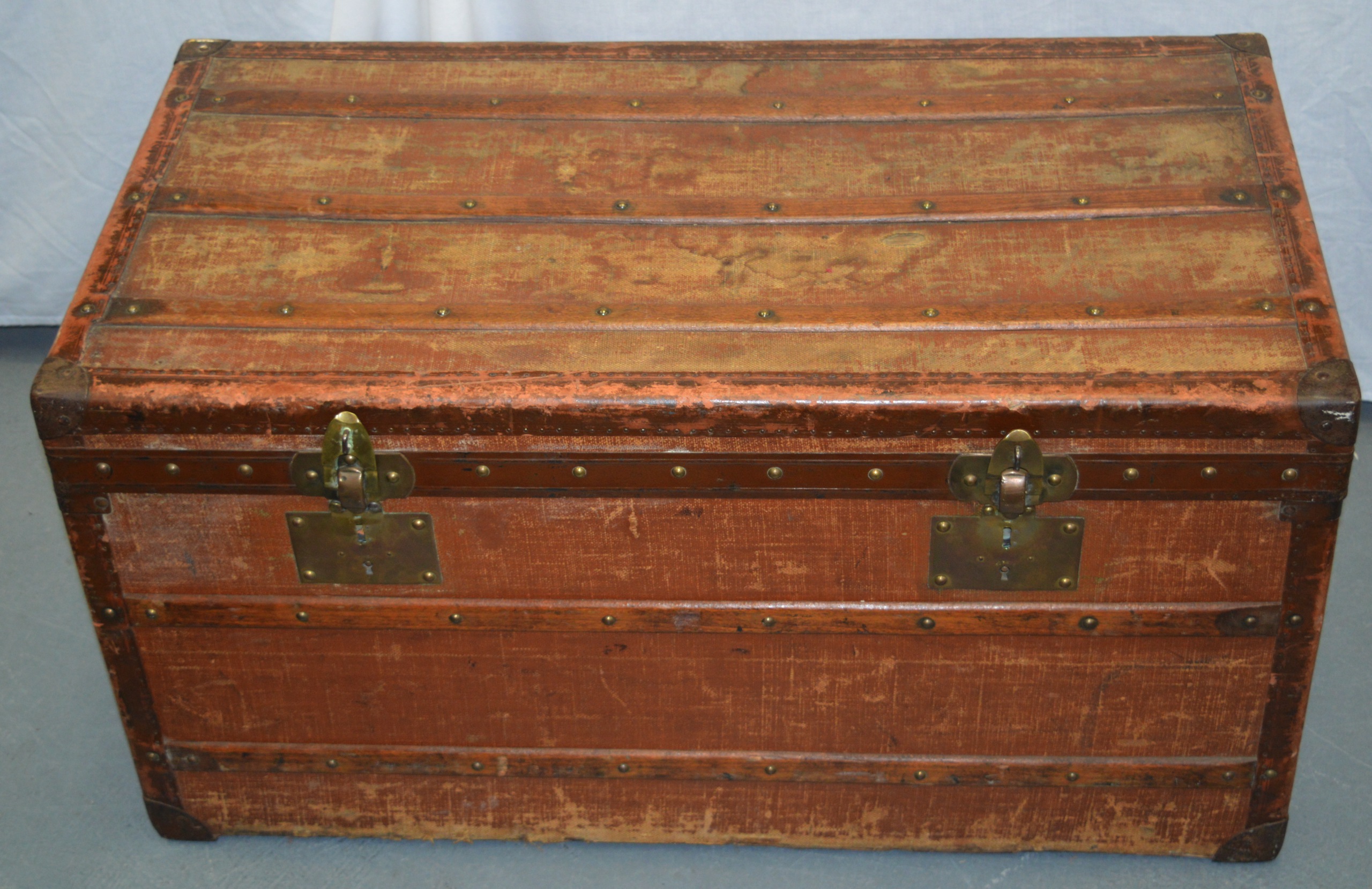 AN ANTIQUE FRENCH LEATHER AND BRASS BOUND TRUNK by Moynat of Paris. 2ft 11ins wide.