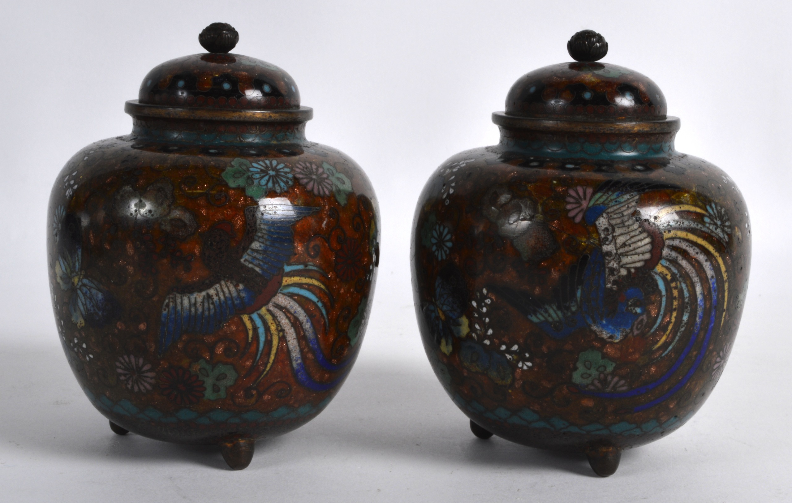 A PAIR OF EARLY 20TH CENTURY JAPANESE MEIJI PERIOD CLOISONNE ENAMEL VASES & COVERS decorated with