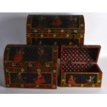 A SET OF THREE GRADIATED INDIAN PAINTED WOOD TRUNKS decorated with figures within a foliate