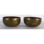 A PAIR OF 19TH CENTURY INDIAN EMBOSSED BRASS BOWLS decorated with birds and foliage. 4.25ins