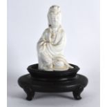 A SMALL EARLY 20TH CENTURY CHINESE BLANC DE CHINE FIGURE OF GUANYIN upon an associated stand. Figure