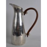 A STYLISH SILVER PLATED ART DECO PITCHER with leather handle. 10.75ins high.