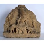 A CHINESE MING DYNASTY CARVED STONE TEMPLE FRAGMENT depicting a Buddhistic figure beside two beasts.