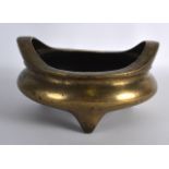 A CHINESE QING DYNASTY TWIN HANDLED BRONZE CENSER bearing Xuande marks to base, supported upon three
