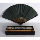 A MID 19TH CENTURY CHINESE EXPORT BLACK LACQUER FAN in original box, painted with beasts and