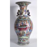 A VERY LARGE MID 19TH CENTURY CHINESE CANTON FAMILLE ROSE TWIN HANDLED VASE painted with panels of