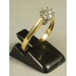 A SOLITAIRE DIAMOND RING, the brilliant cut stone of approximately 0.6cts claw set to a plain 18ct