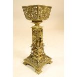 A LATE VICTORIAN BRASS STAND, the dished square bowl supported on a square section column issuing