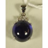 A SAPPHIRE AND DIAMOND PENDANT, the oval cabochon polished sapphire of 16.98cts claw set in 14kt