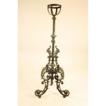 A VICTORIAN CAST IRON AND BRASS TORCHERE, the wrythen fluted column with leaf capped terminals,