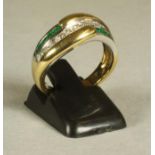 AN EMERALD AND DIAMOND FANCY HALF HOOP RING centred by a wavy band of channel set baguette cut