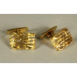 A PAIR OF ANDREW GRIMA STYLE 18CT GOLD CUFFLINKS of cast and pierced asymmetric oblong form with a