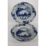 A PAIR OF DELFT PLATES, c.1760, probably Dutch, of dished circular form, centrally painted with a