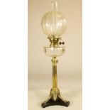 A VICTORIAN BRASS OIL LAMP BASE, the Ionic column raised on three trifurcated supports terminating