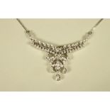 A DIAMOND NECKLACE, the fixed leafy branch pendant with husks and three drop diamonds on a 9ct white