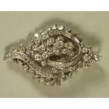 A DIAMOND BROOCH/PENDANT, the open stylised leaf set with numerous brilliant and baguette cut stones