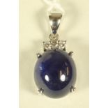 A SAPPHIRE AND DIAMOND PENDANT, the oval cabochon polished sapphire of 27.33cts claw set in 14kt