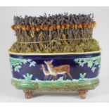 A CONTINENTAL MAJOLICA JARDINIERE, late 19th century, of D-end form moulded with two deer in