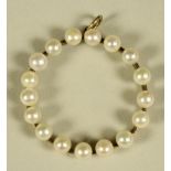 A PEARL SET CIRCLET PENDANT, the knife edge bar with seventeen pearls, unmarked