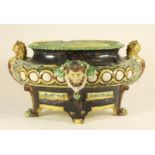 A CONTINENTAL MAJOLICA CISTERN, late 19th century, of oval form with leopard head lug handles raised