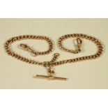 A 9CT GOLD CURB LINK DOUBLE ALBERT CHAIN, with bar and two dog clip fasteners, each chain 7" long,