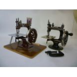 A child's Singer Sewing Machine No 20, with cast iron frame with instructions, 7" wide, and