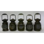 Five similar railway lamps each in japanned metal case, with fluted circular ventilator top, loop