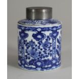 A CHINESE PORCELAIN TEA CANISTER of plain cylindrical form, painted in underglaze blue with panels