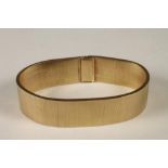 A 9CT GOLD FLEXIBLE CUFF BRACELET, sponsor's mark RMK, London c.1966, with plain clasp, 45g, 7"