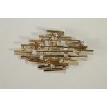 AN 18KT GOLD AND DIAMOND BROOCH, the multi length bars abstract mounted with seven open back