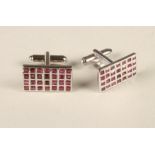 A PAIR OF RUBY CUFFLINKS, each silver oblong panel set with twenty eight square cut rubies