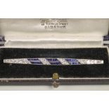 AN ART DECO SAPPHIRE AND DIAMOND BAR BROOCH, the two open triple panelled central bars channel set