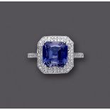 AN ART DECO STYLE SAPPHIRE AND DIAMOND CLUSTER RING, the square cut sapphire of approximately 4.