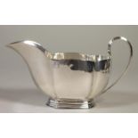 AN ART DECO SILVER SAUCEBOAT, probably by Jos. Williams & Co., London 1932, of lobed oval form