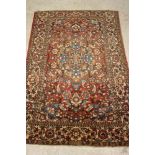 A RUSSIAN ISFAHAN RUG, early 20th century, the red floral field with pale blue central gul and