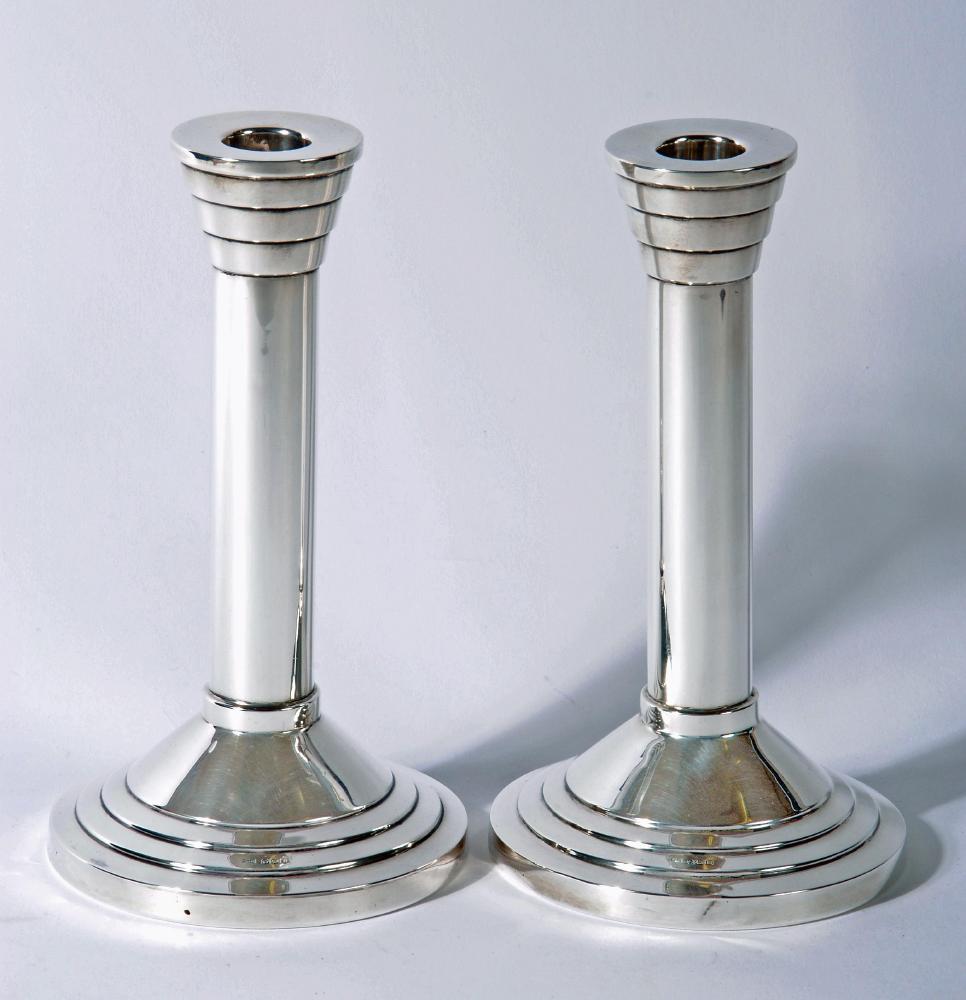 A PAIR OF SILVER CANDLESTICKS, makers Walker & Hall, Sheffield 1955, the fixed flared stepped