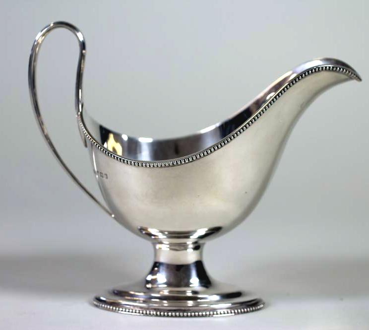 A SILVER PEDESTAL SAUCEBOAT, makers Roberts & Belk, Sheffield 1970, the plain oval bowl with applied