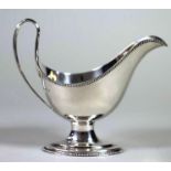 A SILVER PEDESTAL SAUCEBOAT, makers Roberts & Belk, Sheffield 1970, the plain oval bowl with applied