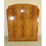 AN ART DECO BURR MAPLE VENEERED TRIPLE WARDROBE of arched stepped tapering form with zebra wood