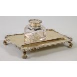 A SMALL SILVER GILT DESK STAND, maker Charles Stuart Harris, London 1921, of rounded oblong form