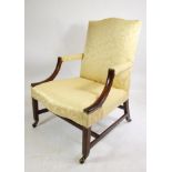 A GEORGIAN MAHOGANY LIBRARY CHAIR of "Gainsborough" type, upholstered in yellow silk damask,