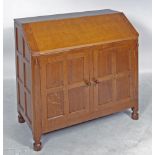 AN ADZED OAK BUREAU by Robert Thompson, the fall front opening to fitted interior and supported by
